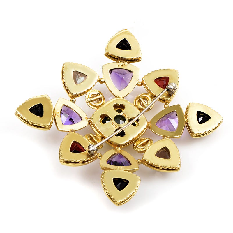 Vibrant in color as well as design, this star-shaped brooch from David Yurman is sure to garner much attention. The brooch is made of 18K yellow gold and is shaped like a star. The star is set with an assortment of faceted gemstones including
