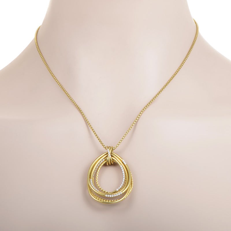 The beauty of this decadent pendant necklace from David Yurman transcends time. The necklace is forged from gleaming 18K yellow gold and boasts a pendant comprised of numerous teardrop-shaped pieces. Lastly, the pendant is set with ~.51ct of