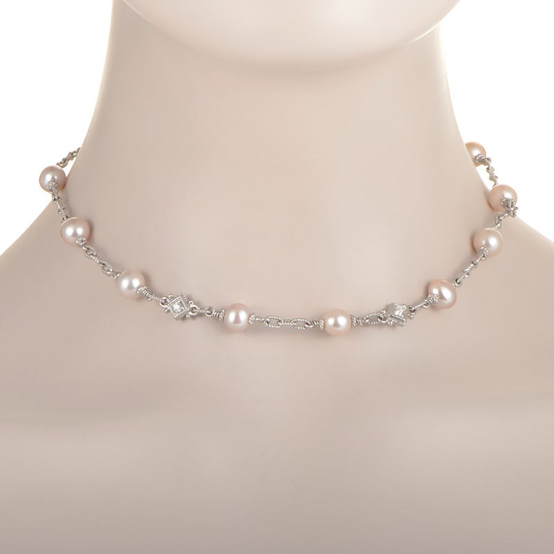 Pretty pink pearls paired with ~.50ct of glittering white diamonds gives this classically designed necklace a whimsical air. The necklace is made of 18K white gold and is in the collar style. Absolutely divine!