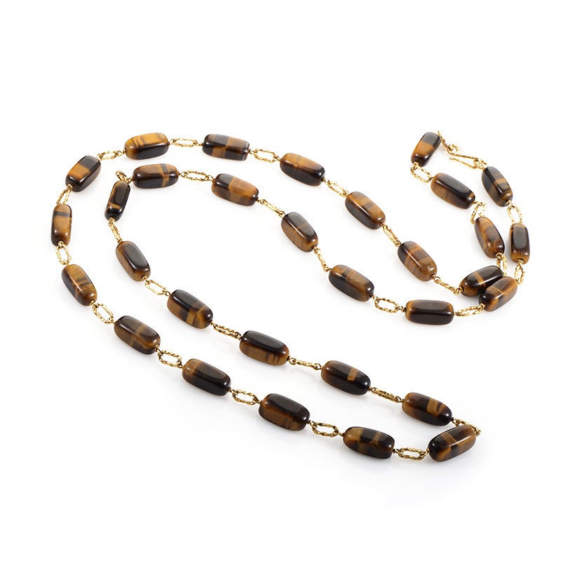The tantalizingly gorgeous and silky luster of tiger's eye is on display in the design of this bold necklace. The necklace is made of 18K yellow gold and is set with 31 stones.

Approximate Dimensions: Drop of the Necklace: 19.00