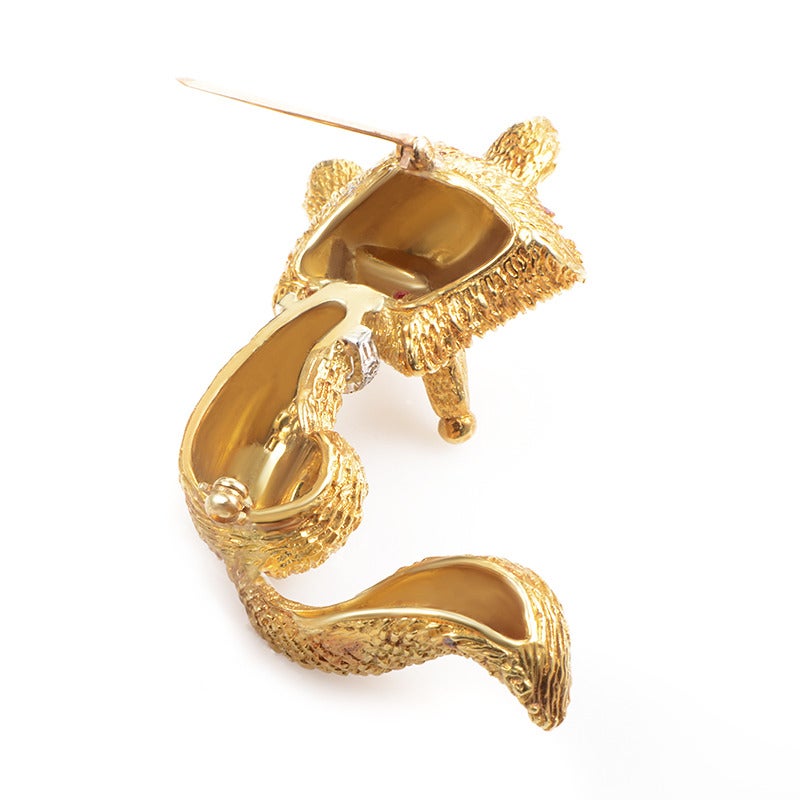 The fox is known as a sly and devious creature, however, you will not be displeased to let this one sneak into your jewelry collection. The brooch is made from carved 18K yellow gold and is accented with diamond-set platinum. Lastly, the fox glowers