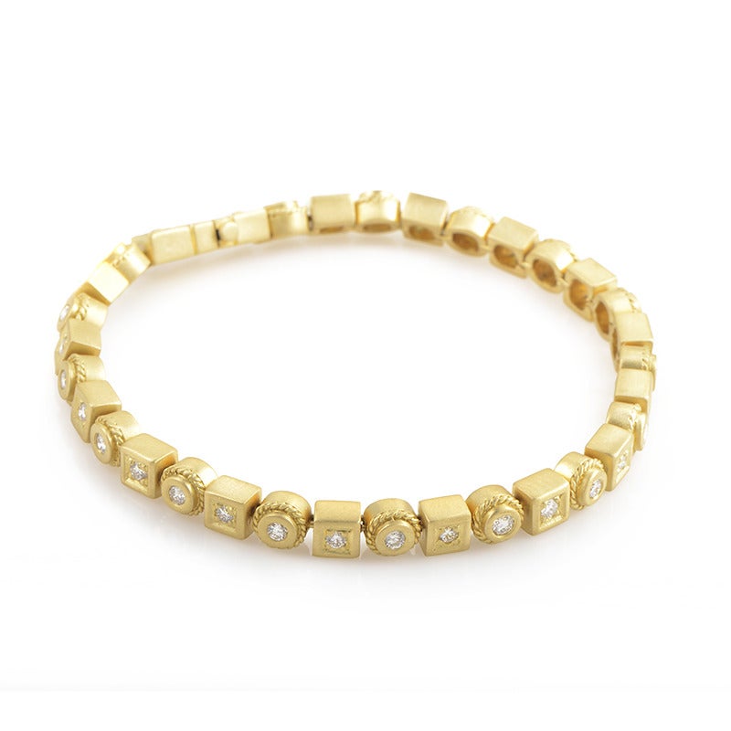 This charming Penny Preville bracelet is splendidly made of 18K yellow gold and consists of round and square shaped elements set alternately, each accented with a brilliant-cut diamond stone. The bracelet weighs 33 grams and the total diamond weight