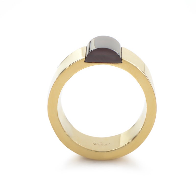 Simple yet memorable design by world-famous Gucci impeccably crafted from 18K yellow gold, accented with a single strikingly red garnet stone.

Ring Size: 5.75 (50 7/8)