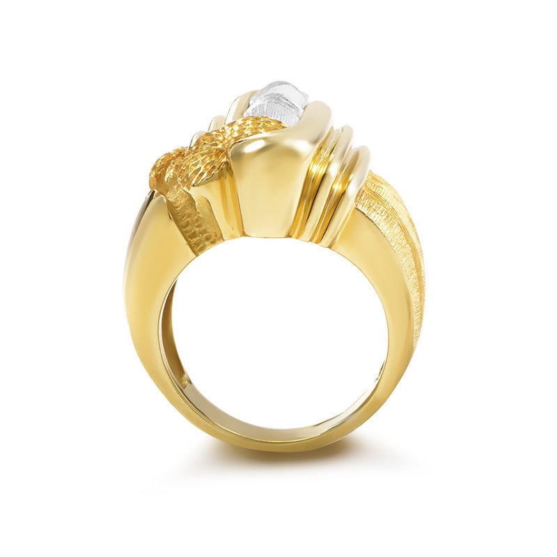 Representing less a jewelry piece and more an artistic masterpiece, this Henry Dunay ring features an exceptionally designed and crafted body made of striking 18K yellow gold, attractively accented with 18K white gold element.

Ring Size: 7.25 (54