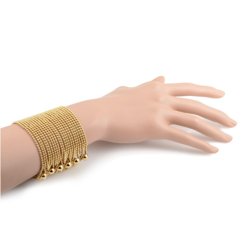 Absolutely divine jewelry piece from Cartier featuring prestigious, upscale design and splendid craftsmanship; it’s made of sophisticated 18K yellow gold and boasts numerous bead bracelets combined into one for a highly glamorous look.