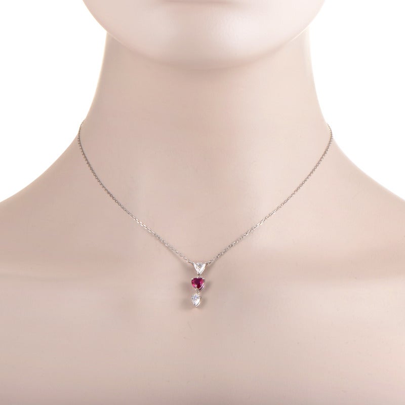 A lovely, charming necklace by Mikimoto made of elegant 18K white gold, featuring neatly crafted thin rolo chain onto which a gorgeous pendant is attached, boasting two exquisite diamond stones and an attractive ruby. The diamonds weigh 0.56ct and