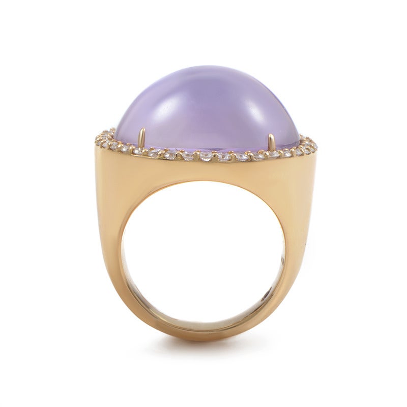Dreamy and serene, this cocktail ring from Roberto Coin boasts a timeless design that is an instant classic. The ring is made from 18K rose gold and boasts a diamond-set bezel. Lastly mother of pearl covered with an amethyst overlay is sure to