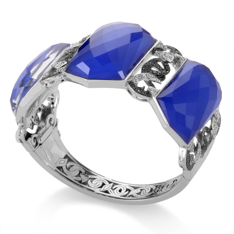 This stupendous Stephen Webster cuff with intriguing poison ivy motifs is made of prestigious 18K white gold and boasts lapis, white quartz and 1.67 carats of diamond stones.

Included Items: Manufacturer's Box