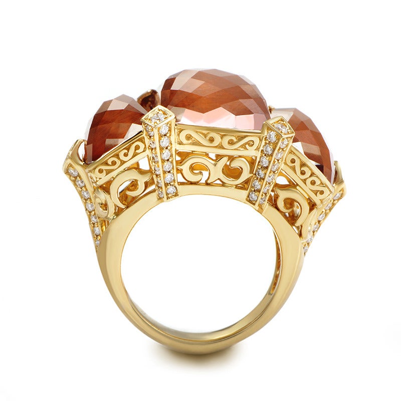 This decadent ring from Stephen Webster is bold and beautiful- perfect for a fashion-forward lady! The ring is made of 18K yellow gold and features shanks and an ornately designed bezel set with ~.58ct of diamonds. Lastly, three faceted bulls-eye