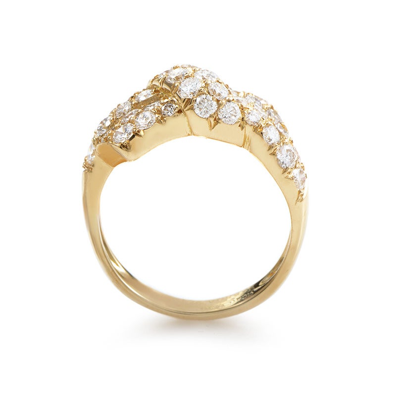 This exceptional ring by Van Cleef & Arpels features glamorous, lavish design perfect for accessorizing fashionable looks with a touch of extravagance; the ring is made from sophisticated 18K yellow gold and set with spectacular diamond stones