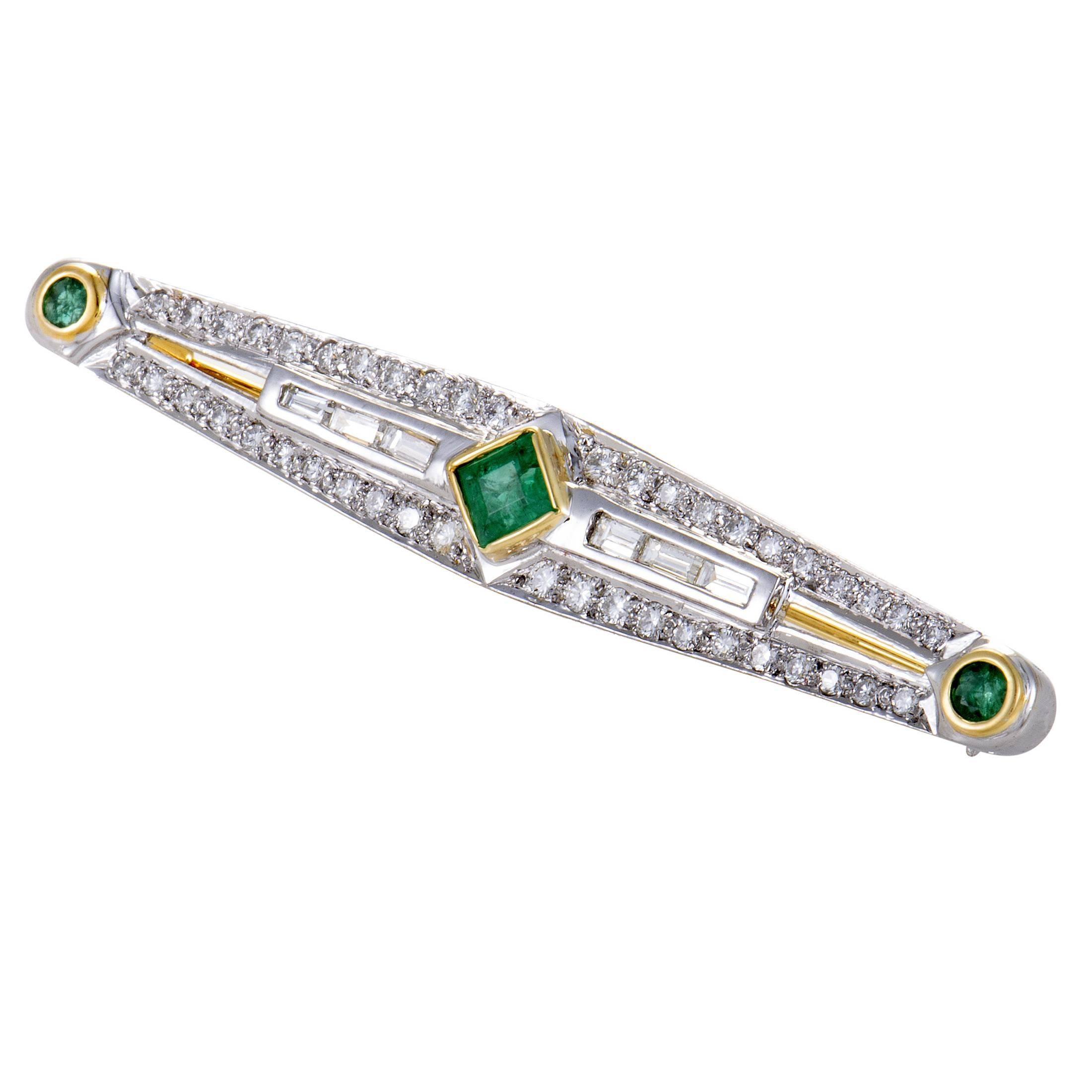 While shimmering 14K white gold and sparkling diamonds totaling approximately 1.35 carats set a bright overall tone for this exceptional antique brooch, warm 14K yellow gold and stunning emeralds amounting to 0.75ct add vivid color to the charming
