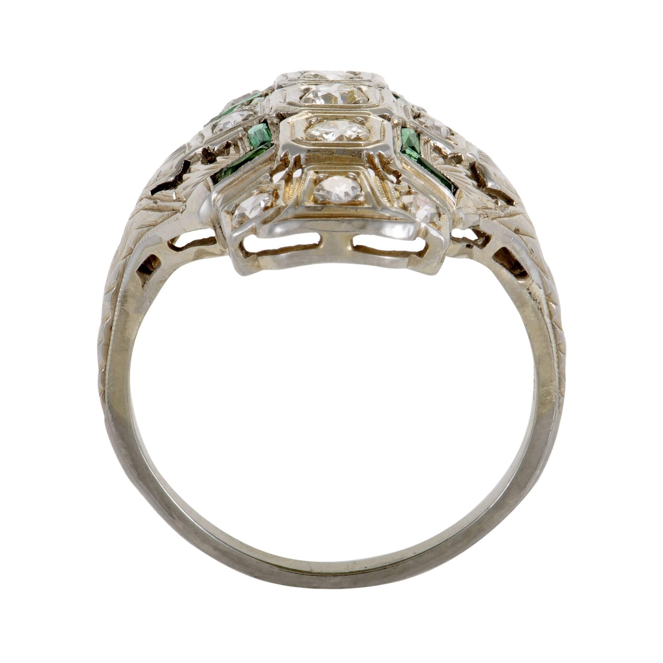 Wonderfully arranged across the splendidly bright surface of 18K white gold, the resplendent diamonds amounting to 0.50ct and precious emeralds weighing in total 0.30ct produce an exceptional allure in this fascinating ring.