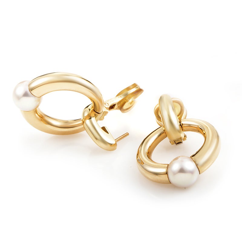 With a classic, timeless look, these Cartier earrings will complement elegantly any fashionable look; they are made of sophisticated 18K yellow gold and accented stylishly with pearls.