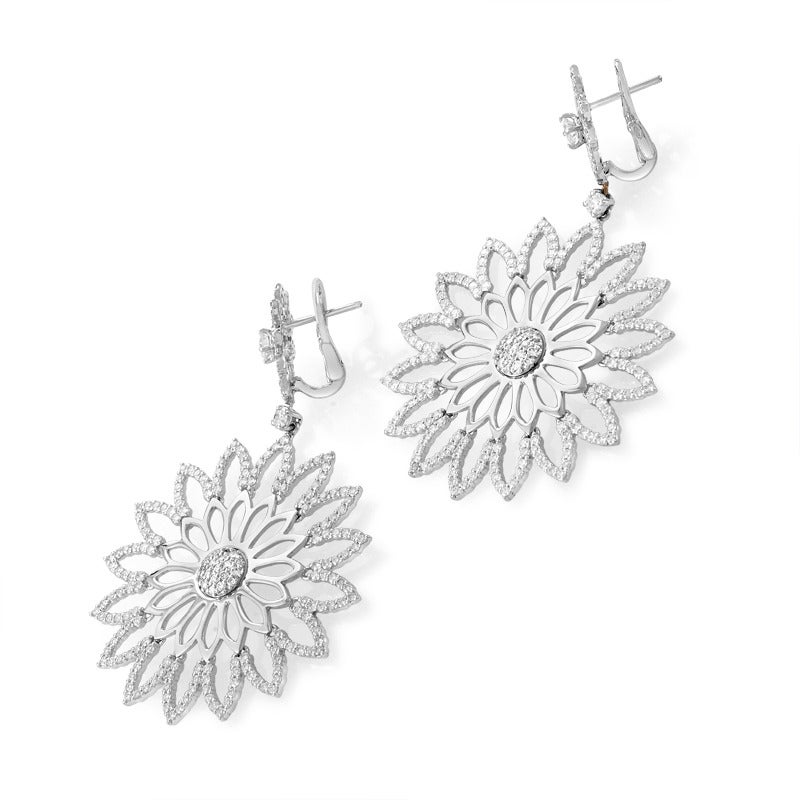 Embellishing with numerous perfectly cut diamonds these splendid flower-shaped earrings, Crivelli designers achieved an artistic and gorgeous appearance. The earrings have a drop of 2.25 inches, they are made of 18K white gold and each weighs nine