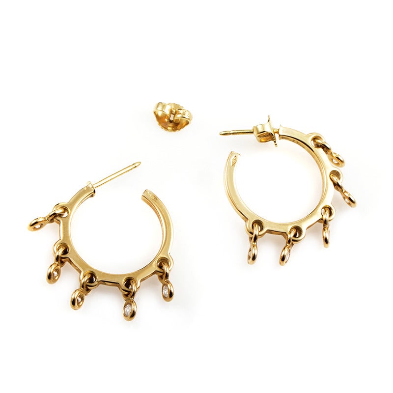 A delightful pair of earrings from Dior, featuring gorgeous hoop-shaped bodies accented imaginatively with diamonds. The pair is made of 18K gold and each earring weighs four grams.

Included Items: Manufacturer's Box