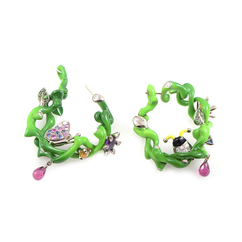 These interesting colorful earrings from Dior draw inspiration from the vivacious beauty of nature; they are made of 18K white gold and boast delightful decoration of diamonds and other gems.

Included Items: Manufacturer's Box