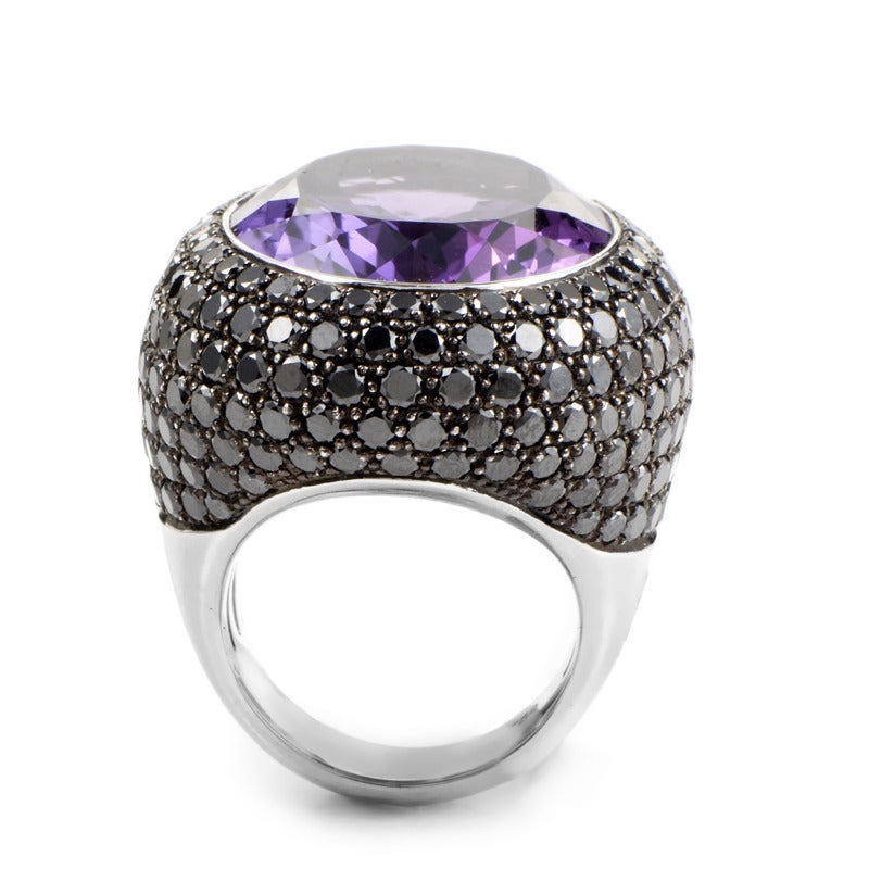 A splendid example of the finest in French luxury, this cocktail ring is without comparison! The ring is made of 18K white gold and is set with a spectacular ~30ct amethyst. Lastly, the ring's bezel is set with a dazzling pave of ~8.05ct of black
