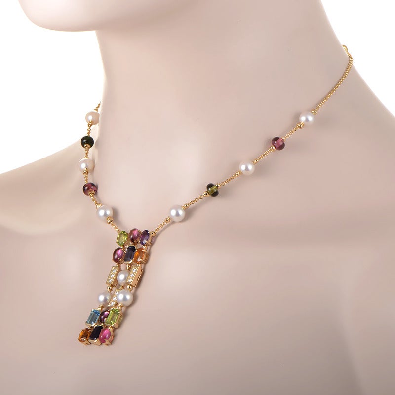 Bulgari's Allegra collection embodies the brand's distinctive use of colored gemstones for a distinctive and playful elegance. This 3-row long pendant necklace is made of 18K yellow gold and boasts a pendant set with pink and green tourmaline,