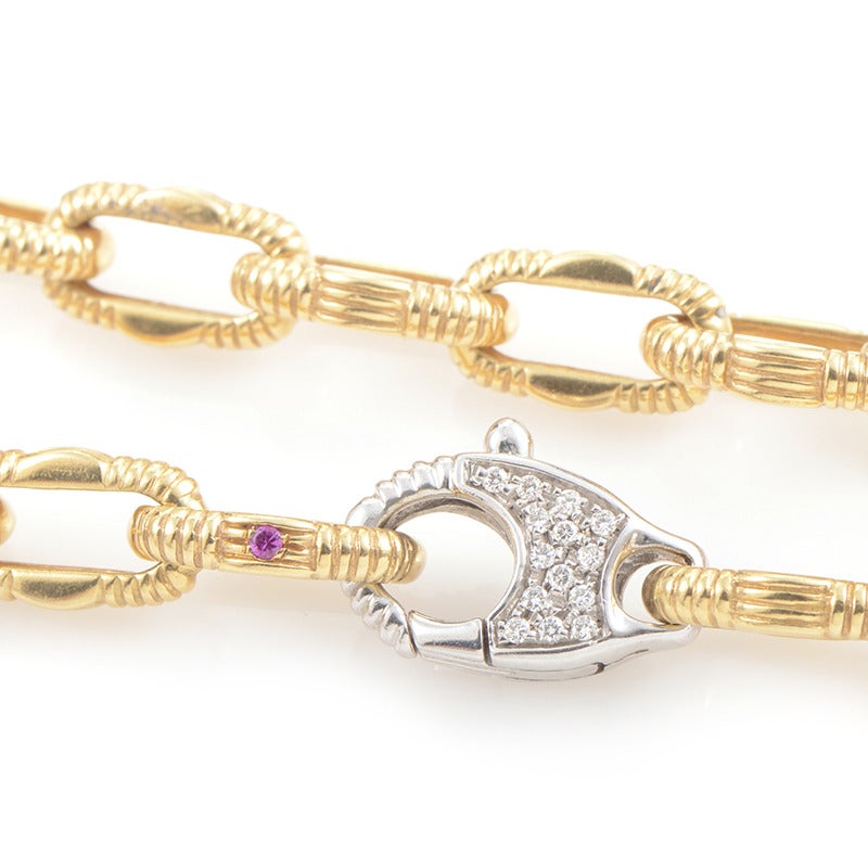 An exemplary necklace by Roberto Coin, boasting classic yet imaginatively crafted link design; the necklace is made from sophisticated 18K yellow gold, featuring a diamond-set lobster claw clasp in 18K white gold, both securing the piece and acting