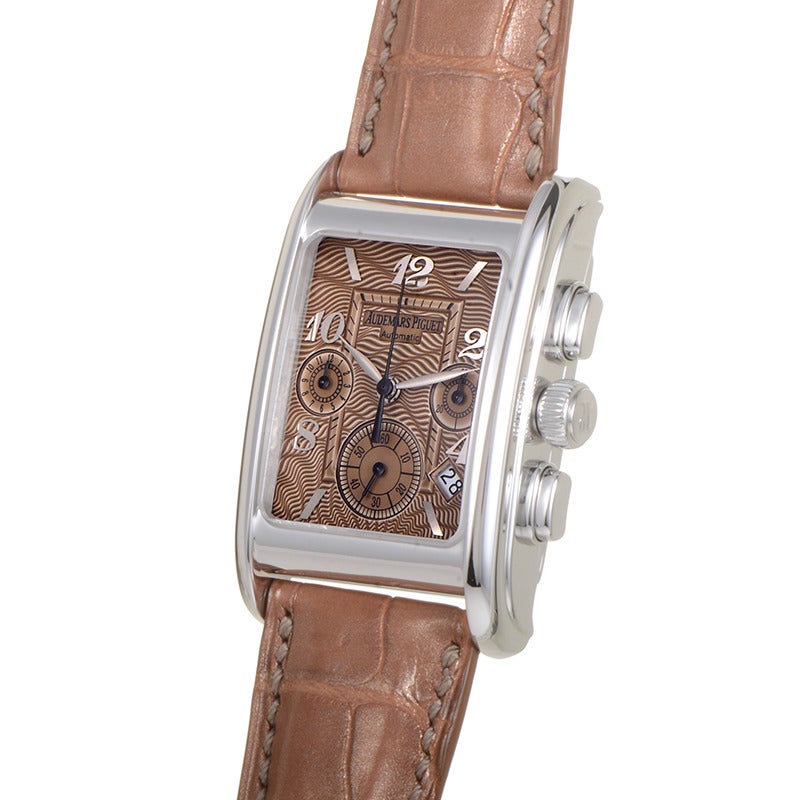 Audemars Piguet gents' stainless steel automatic wristwatch with matching bezel on a brown alligator leather strap. Watch displays indication of hours, minutes, date and a chronograph on a brown wave-patterned dial.