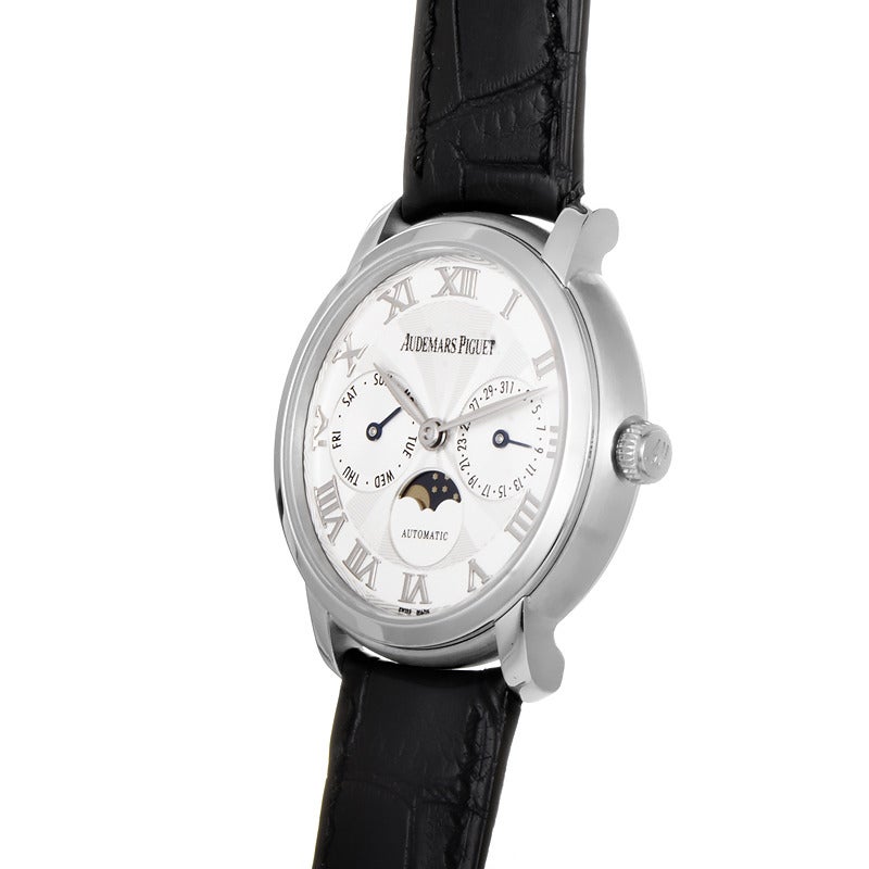 Audemars Piguet unisex 18K white gold automatic wristwatch with a matching bezel on a black leather strap. Watch displays indication of hours, minutes, date and moon phase indication on a silvered dial. Watch resists water to ~20 meters/65 feet.