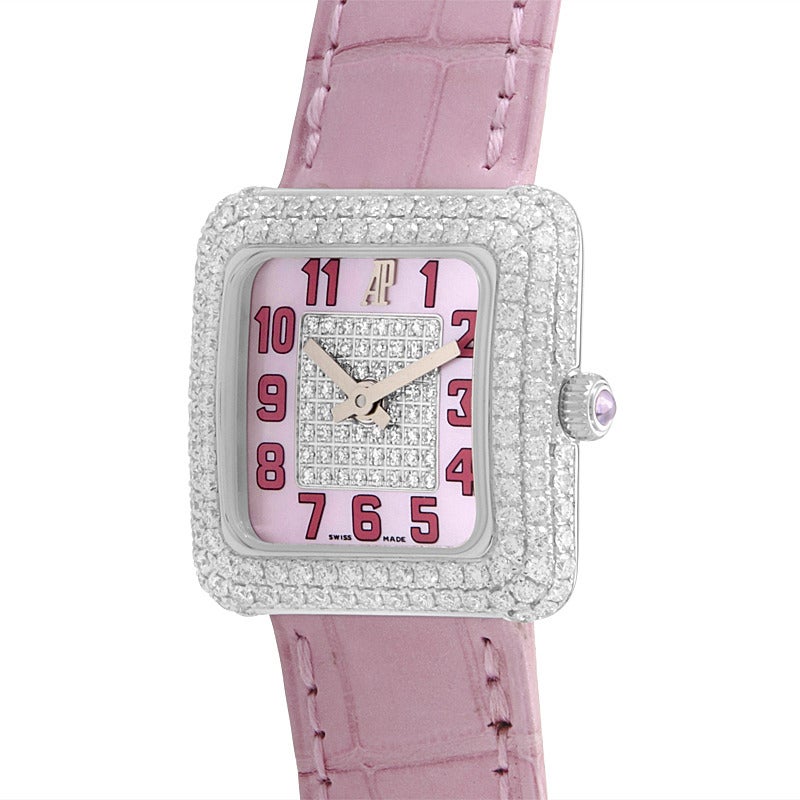Audemars Piguet lady's 18K white gold quartz wristwatch with diamond-set bezel on a pink alligator leather strap. Watch displays indication of hours and minutes on a pink partially diamond paved dial.