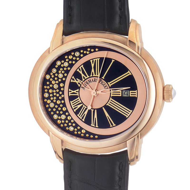 Audemars Piguet lady's 18K rose gold automatic wristwatch with matching bezel on a black crocodile leather strap. Watch displays indication of hours,minutes, seconds and date on a black and rose gold dial with diamond accents. 
