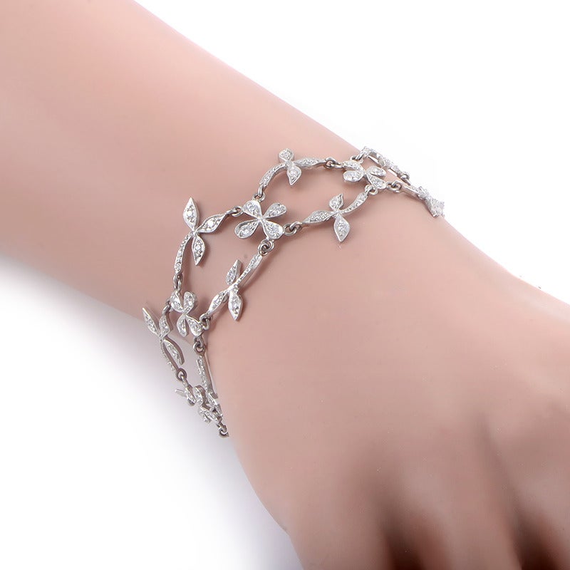 This piece has an ethereal design that is sure to catch your fancy. The bracelet is comprised of delicate platinum flower motifs set with ~1ct of shimmering white diamonds.