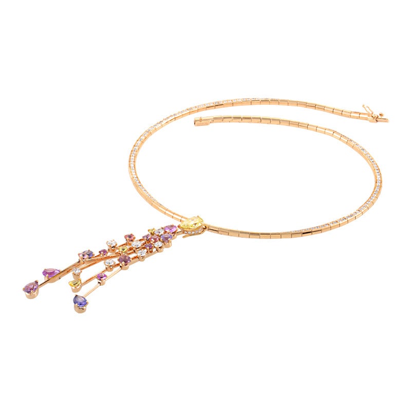 The dazzling cascade of colored gemstones found in the design of this ravishing Chanel necklace is sure to catch your eye and steal your heart. The necklace is made of 18K rose gold and boasts a magnificent pendant comprised of yellow and white
