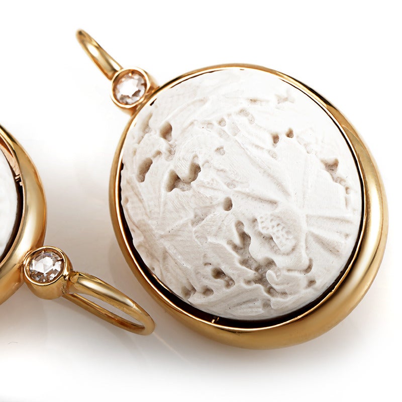 Gorgeous carvings paired with the classic glamour of gold and diamonds makes this pair of earrings from Pomellato a true standout! The earrings are made of 18K yellow gold and are accented with carved white coral. Lastly, the top of each earring is