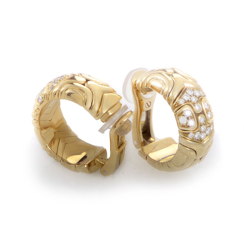 With their 18K yellow gold bodies carved in an impressively ornate fashion, these excellent earrings from Bulgari are embellished further with 0.65ct of delicate diamonds.