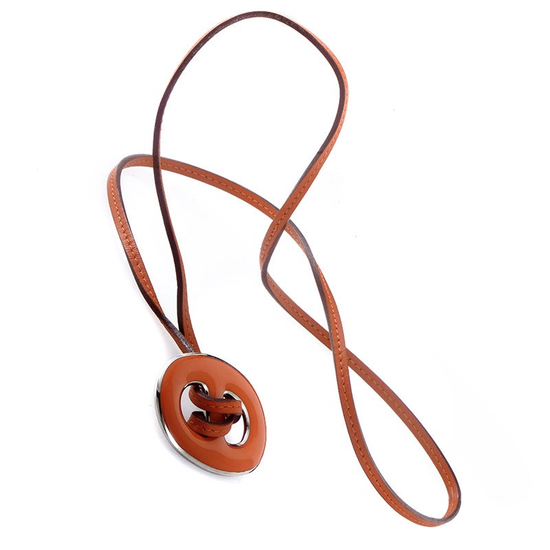 Featuring a striking, offbeat design, this imaginative necklace from Hermes consists of a recognizable enamel chaine d'ancre pendant and a lovely strap of matching color.
Included Items: Manufacturer's Box
Approximate Dimensions: Drop of the