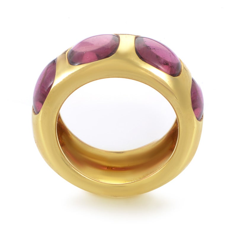 Delightfully round and impeccably polished, this charming 18K yellow gold ring from Pomellato is harmoniously embellished with four expertly set adorable pink tourmaline stones.

Ring Size: 7.5

Included Items: Manufacture's Box