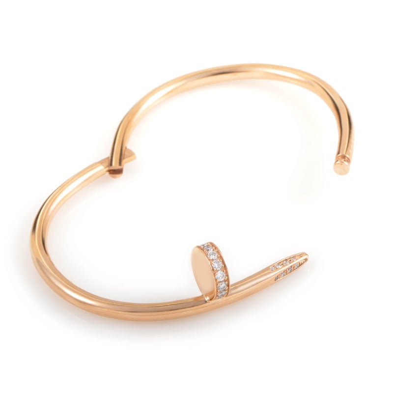 A luxurious variation of an ordinary item, this imaginative Cartier bracelet features a curved nail made of 18K rose gold accented with sparkly diamond stones. The bracelet weighs 31 grams and measures 2.25 inches in diameter.