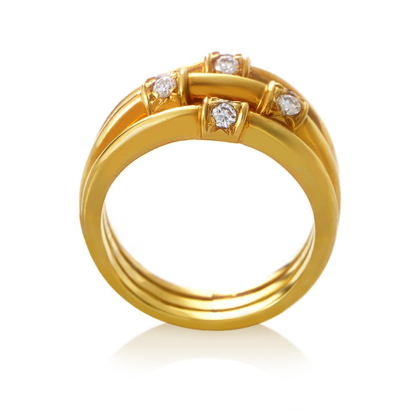 This spectacularly designed ring from Dior features three 18K yellow gold bands forged together and accented with impressively placed diamond stones weighing 0.20ct in total.
Ring Size: 4.5 (47 3/4)