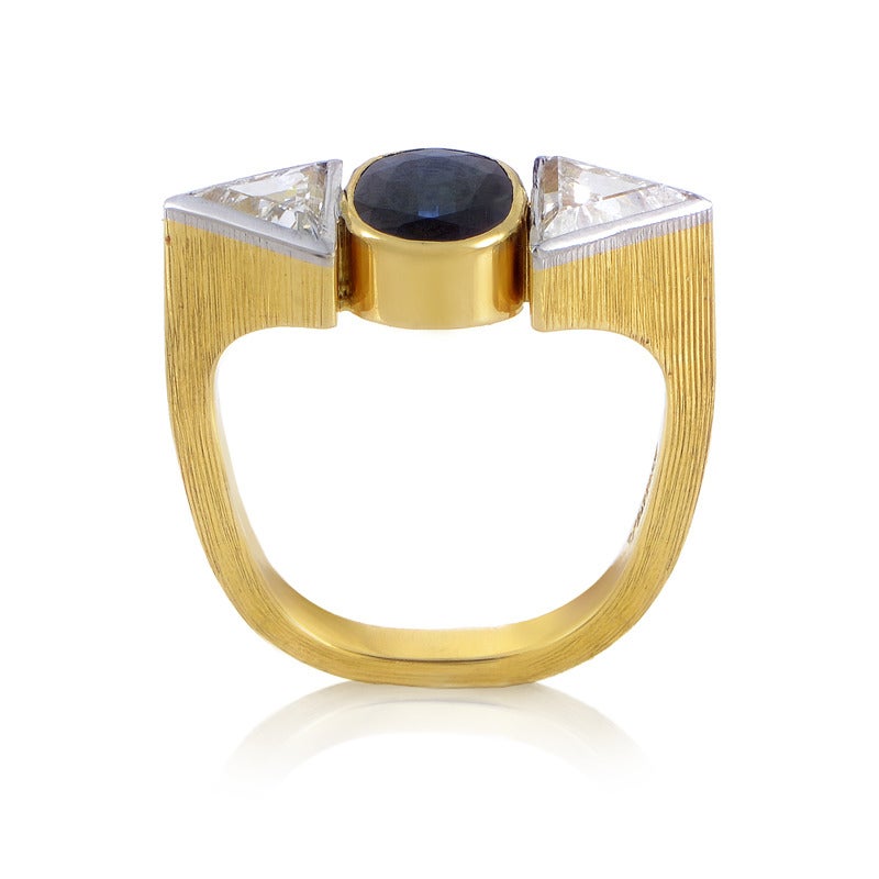 With a rather offbeat design this Grima ring boasts striking, memorable appearance. It’s made of 18K yellow gold and features approximately 1.20 carats of diamonds and a magnificent 1.70ct sapphire stone in the center.
Ring Size: 5.25 (49 5/8)