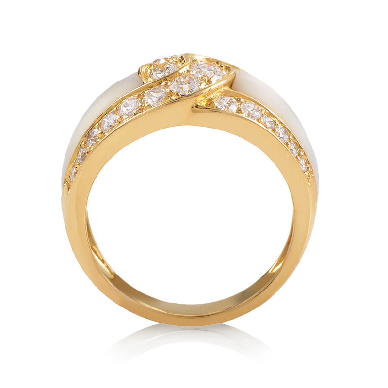 Portraying the idea of infinity in a charming, elegant manner, two symmetric 18K yellow gold loops entwine harmoniously on this exquisite ring from Van Cleef & Arpels, set with 1.50 carats of diamonds and enriched with the marvelous mother of pearl