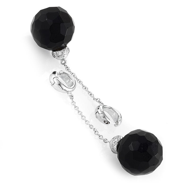 Don yourself in elegance with this sultry and sophisticated pair of earrings from Pomellato! The earrings are made of 18K white gold and are each accented with a faceted black garnet bead and white diamonds.

Diamond Carat Weight: 0.38
Included