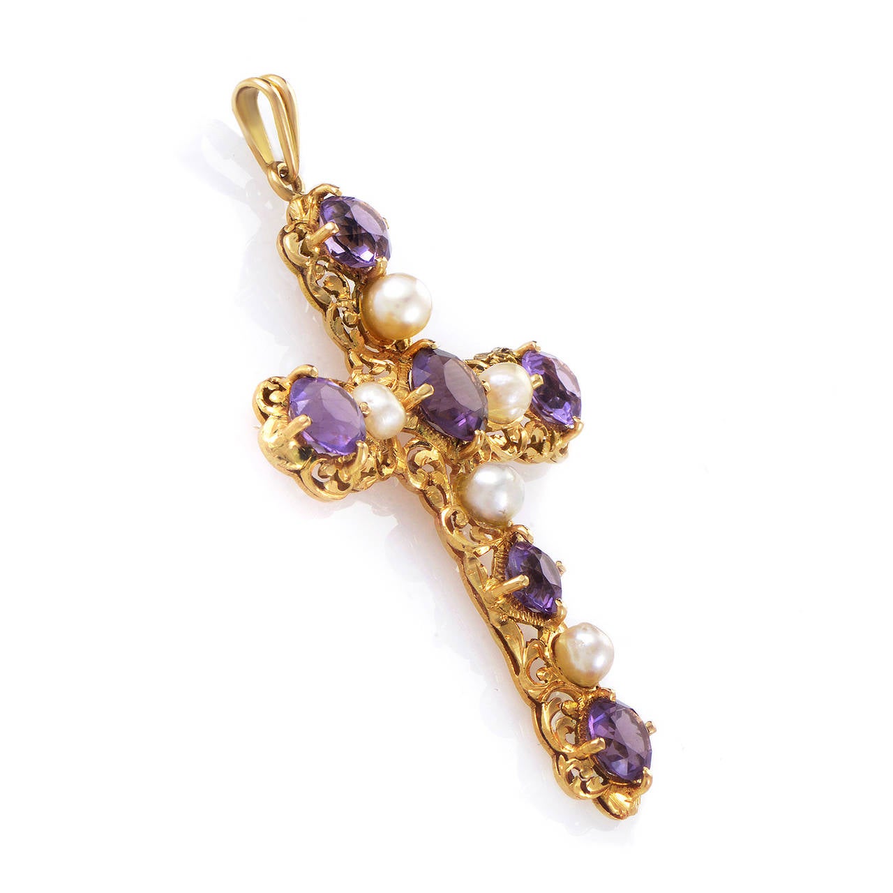 A unique take on a classic design, this pendant is perfect for a lady who enjoys classic style with a twist. The pendant is made of 18K yellow gold and is set with amethysts and pearls.