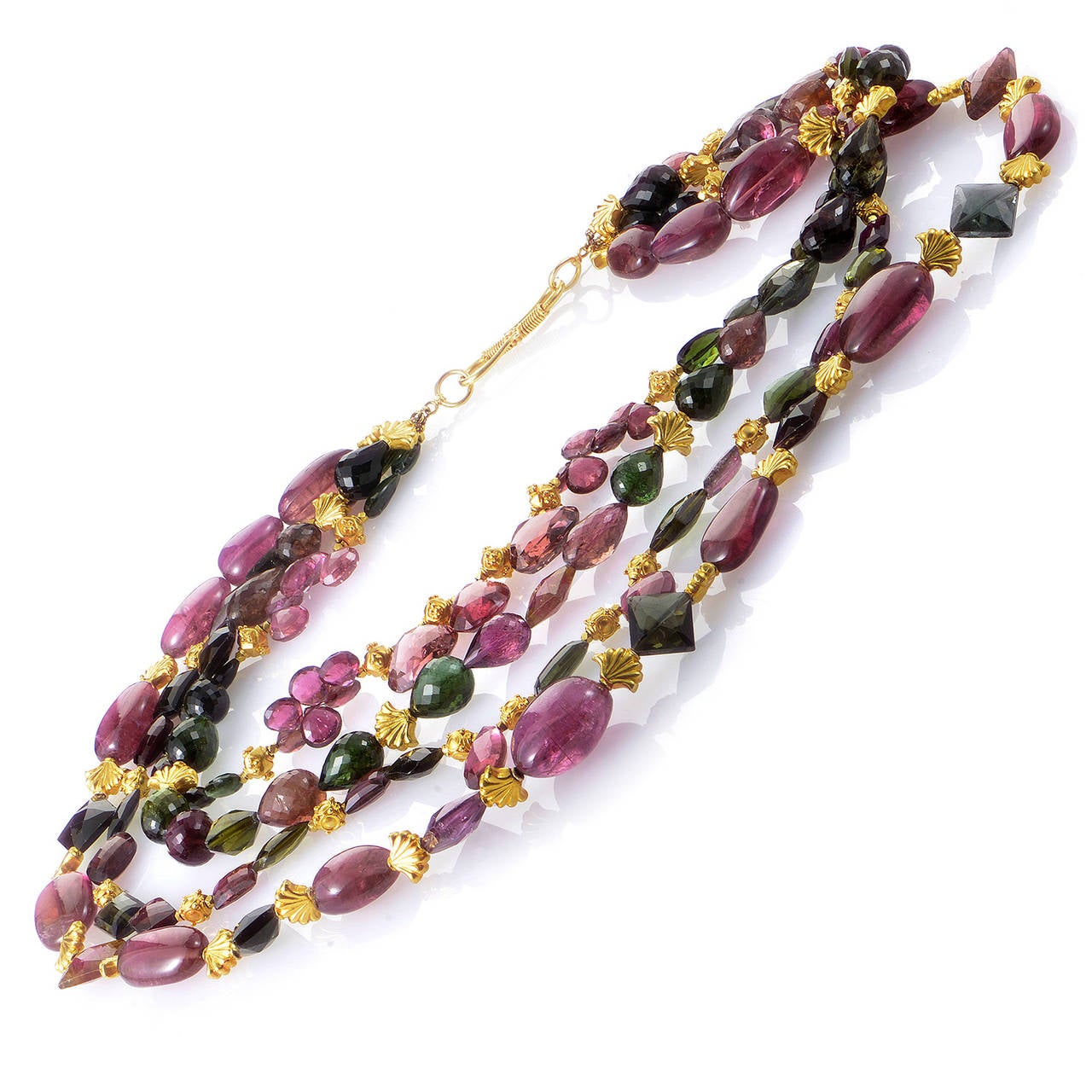 The tantalizingly gorgeous and colorful glow of this necklace is without comparison. The necklace is made of 18K yellow gold and boasts four strands of pink and green tourmaline beads.