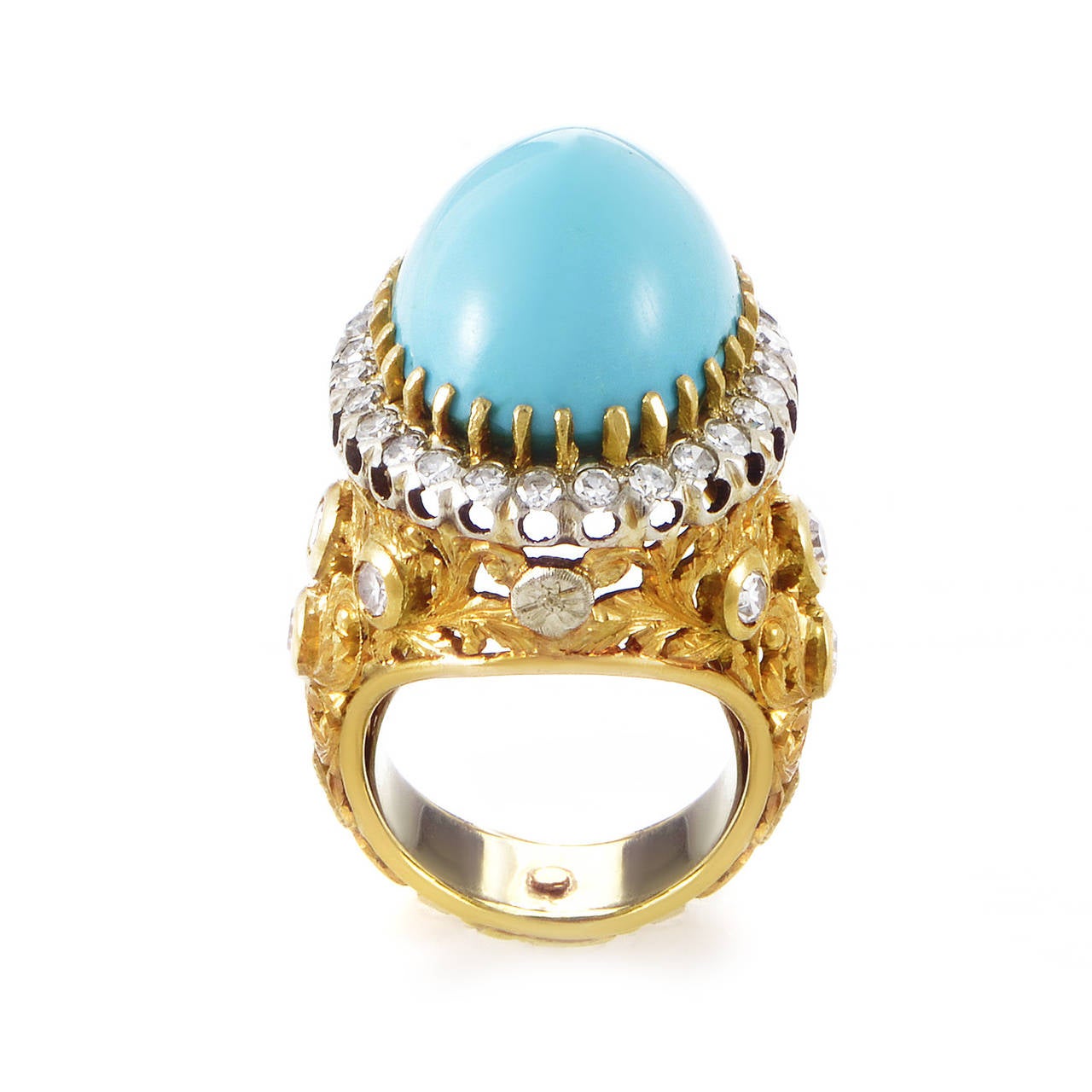Regal and refined are the perfect words to describe this lustrous ring. The ring boasts elegantly carved shanks set with diamond accents. The bezel is also set with diamonds and holds a turquoise cabochon main stone in place with prongs.

Ring