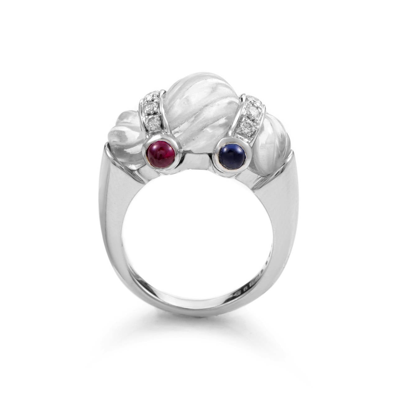 Light and ethereal are the perfect words to describe this gem-laden ring from Boucheron. The ring is smade of 18K white gold and is accented with three gorgeously carved white crystals. Lastly, emerald, ruby, and sapphire cabochons paired with white
