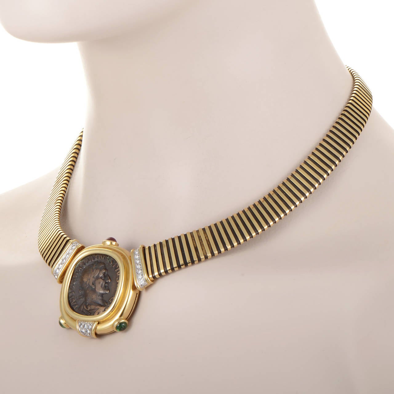 This vintage necklace from Bulgari's Monete Collection is extremely rare and is perfect for a serious jewelry aficianado. The necklace is made of a combination of 18K yellow gold and platinum that comes together at a yellow gold pendant. The pendant