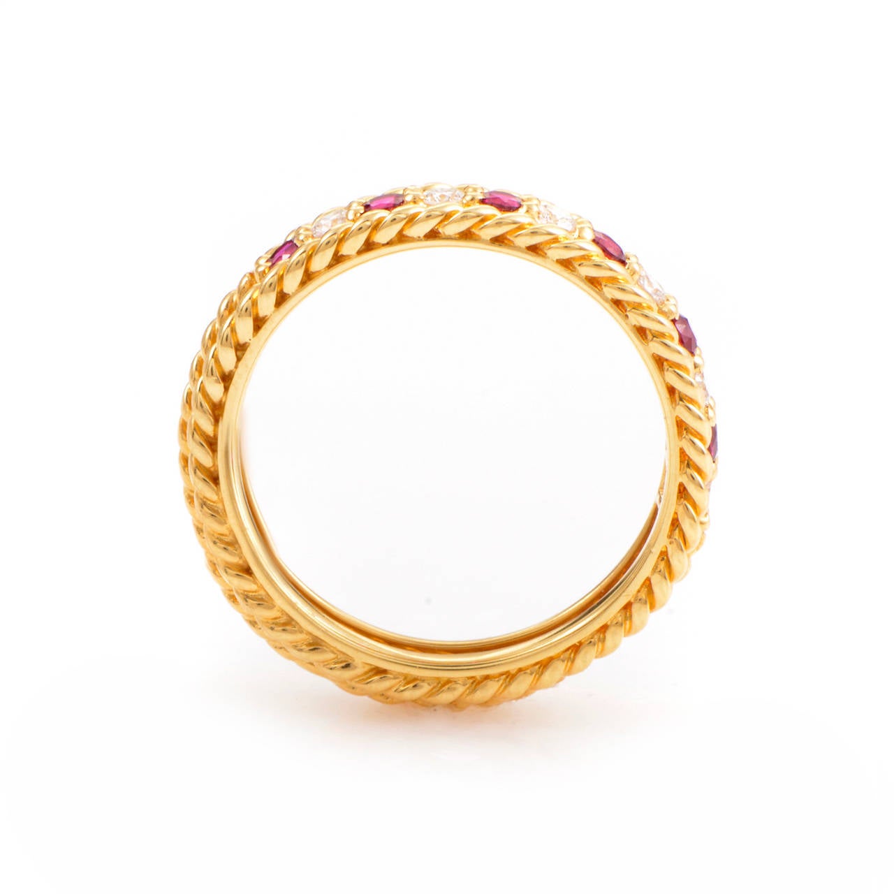 This band ring from Dior has an enduring quality that will keep it in fashion for many years to come. The ring is made of 18K yellow gold and is set with ~.35ct of rubies as well as ~.30ct of shimmering white diamonds.
Included Items: Manufacturer's