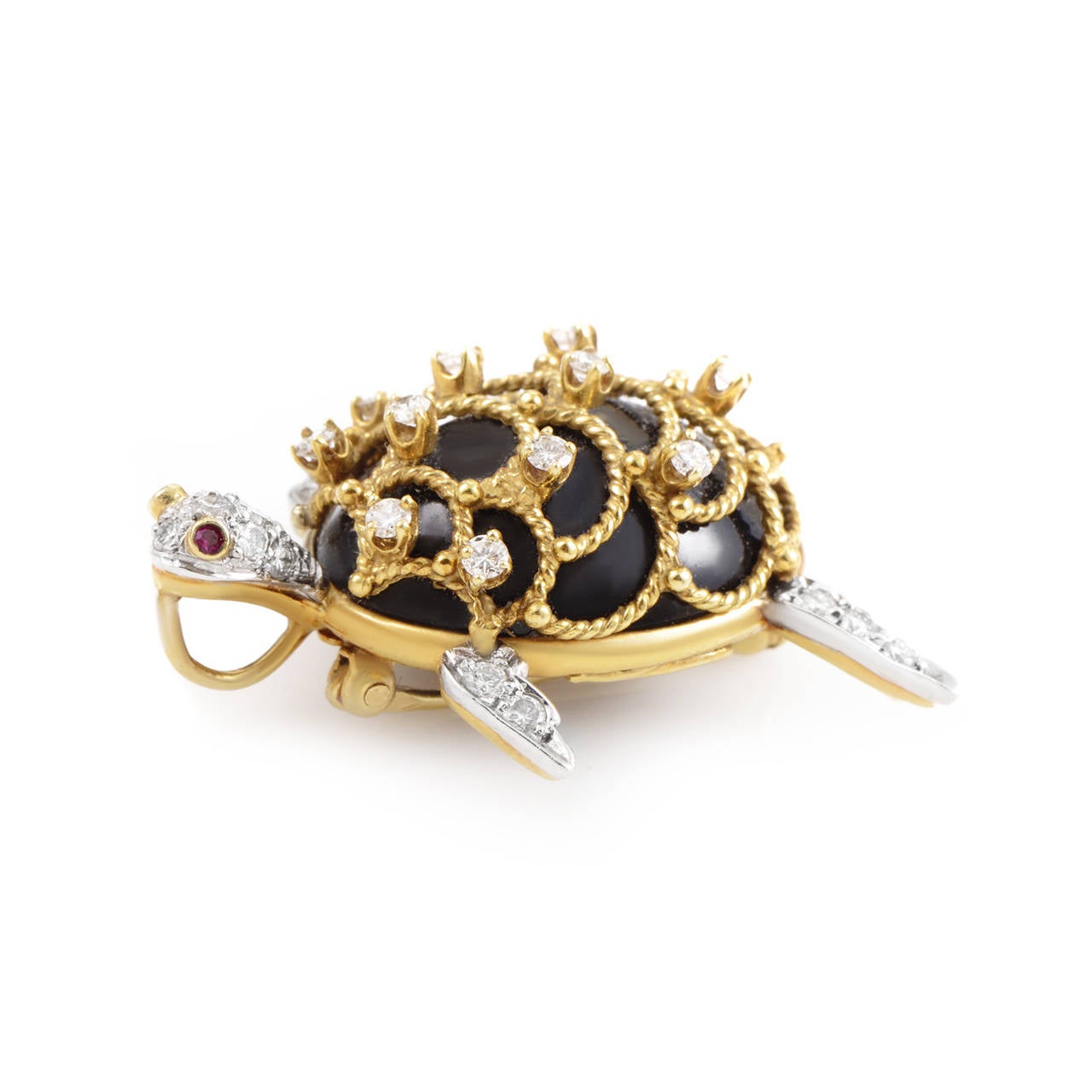 This unique design from Hammerman Brothers is perfect for a lady who likes multi-functional accessories. This brooch/pendant depicts a turtle and is made of a combination of 18K yellow gold and platinum. The turtle's shell is accented with enamel