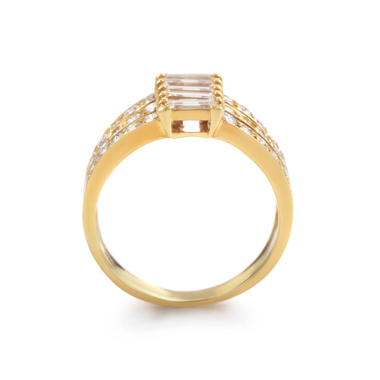 The shimmering, decadently crafted design of this ring from Van Cleef & Arpels is sure to take your breath away! The ring is comprised of three 18K yellow gold bands forged together to make one. Lastly, the bands are set with round brilliant