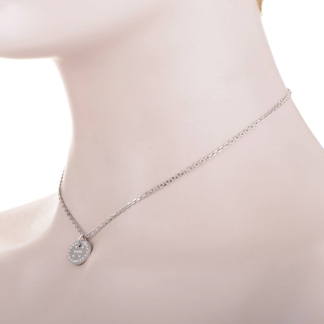 This pendant necklace from Hermes' Eclipse collection is is simple and sweet. The necklace is made of 18K white gold and boasts a disc-shaped pendant set with diamonds and displaying the brand's signature 