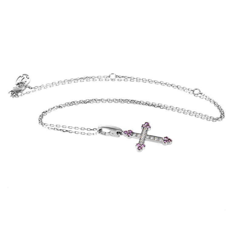 The combination of pink and white gems found in this Cartier pendant necklace are feminine and lovely, while remaining very refined. The pendant necklace is made of 18K white gold and features a crucifix pendant set with an ~.22ct diamond pave.