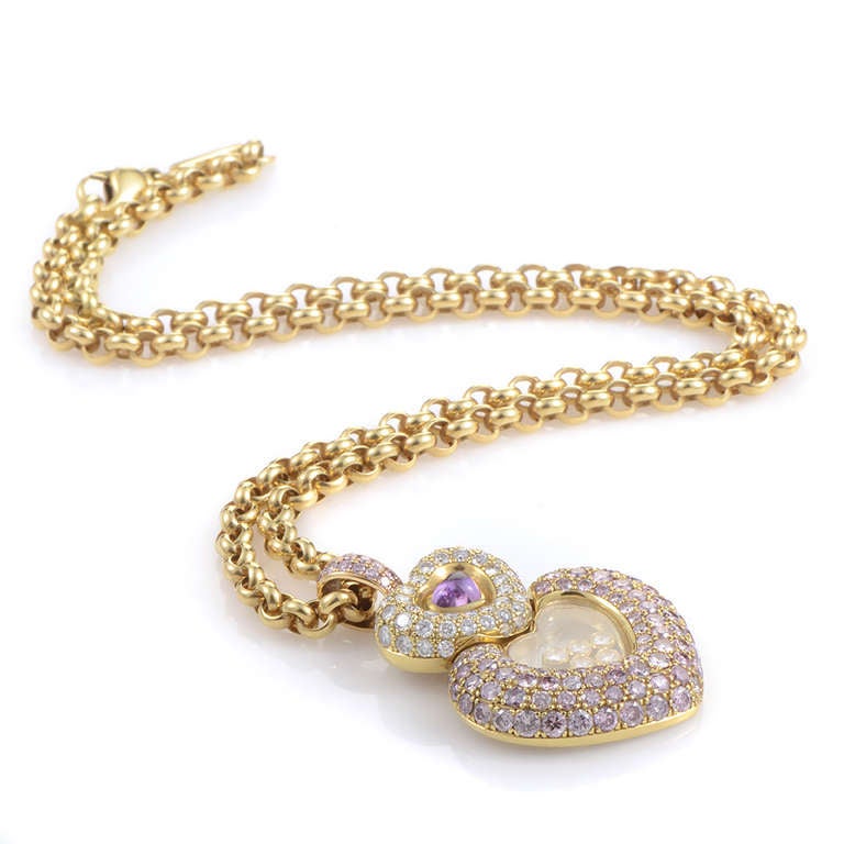 This ultra-feminine pendant necklace from Chopard's Imperiale collection is sure to take your breath away! The necklace is made of 18K yellow gold and features a pendant with two overlapping heart-shaped accents. The smallest heart is set with a