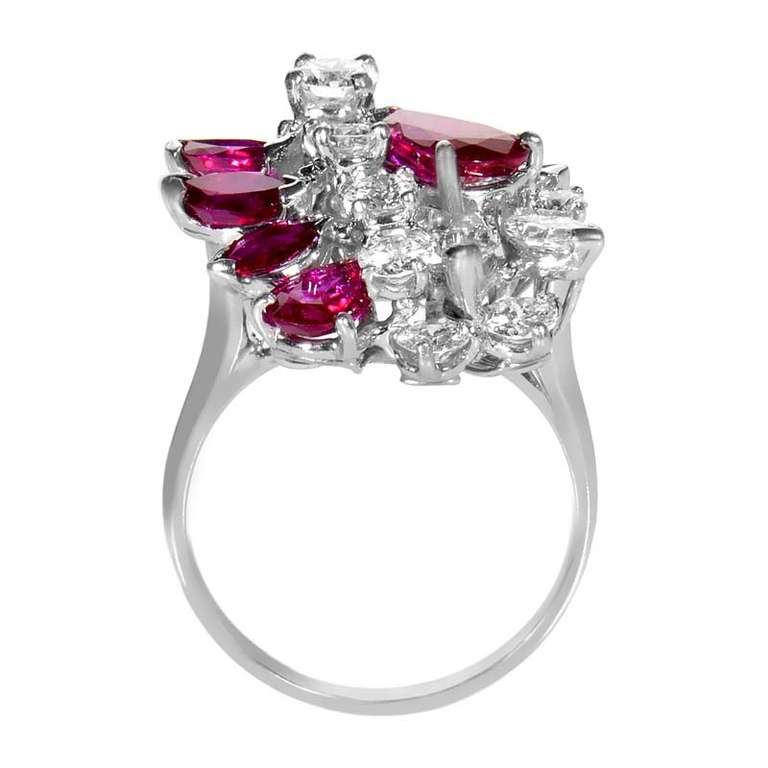 This custom designed antique ring from Oscar Heyman is in a class by itself due to its regal collection of gems. The ring is made of platinum and is set with ~1.74ct of diamonds. Lastly, ~2.71ct of rubies add a splash of color to the design. This